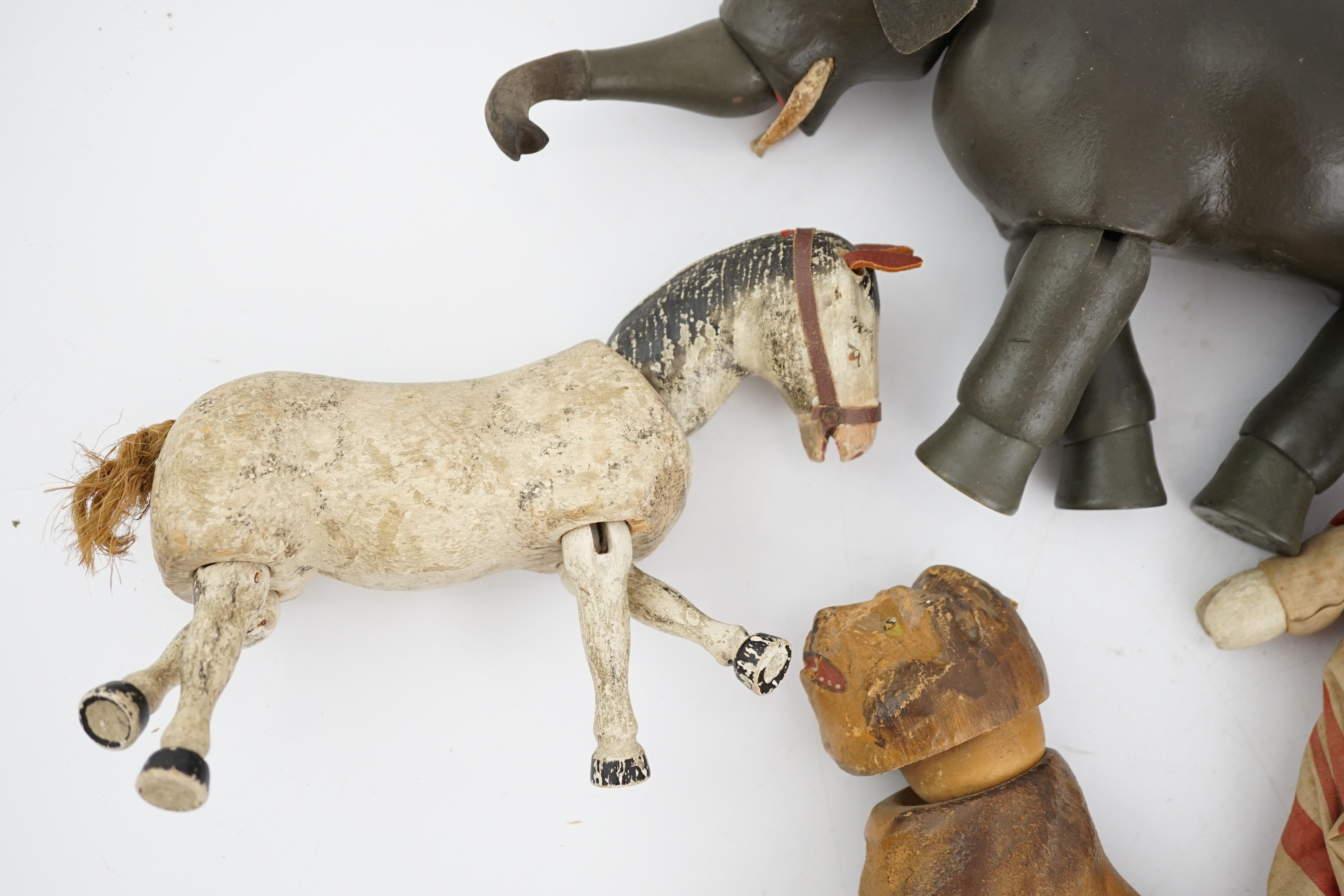 A Schoenhut Humpty Dumpty Circus, early 20th century, including elephant, lion house and other pieces, a playbarn (10) plus a peg doll and a German tinplate clockwork dog